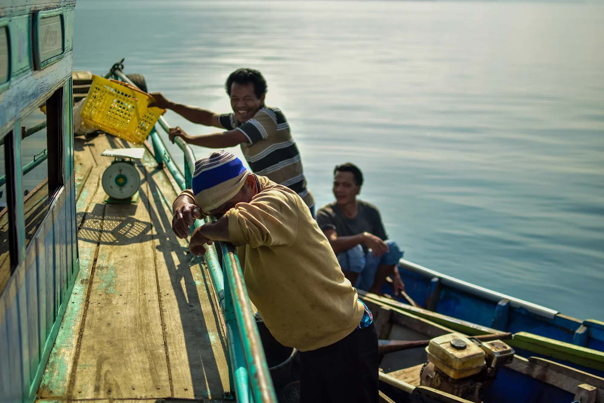 Fishmongers cleaning nets on Lake Toba