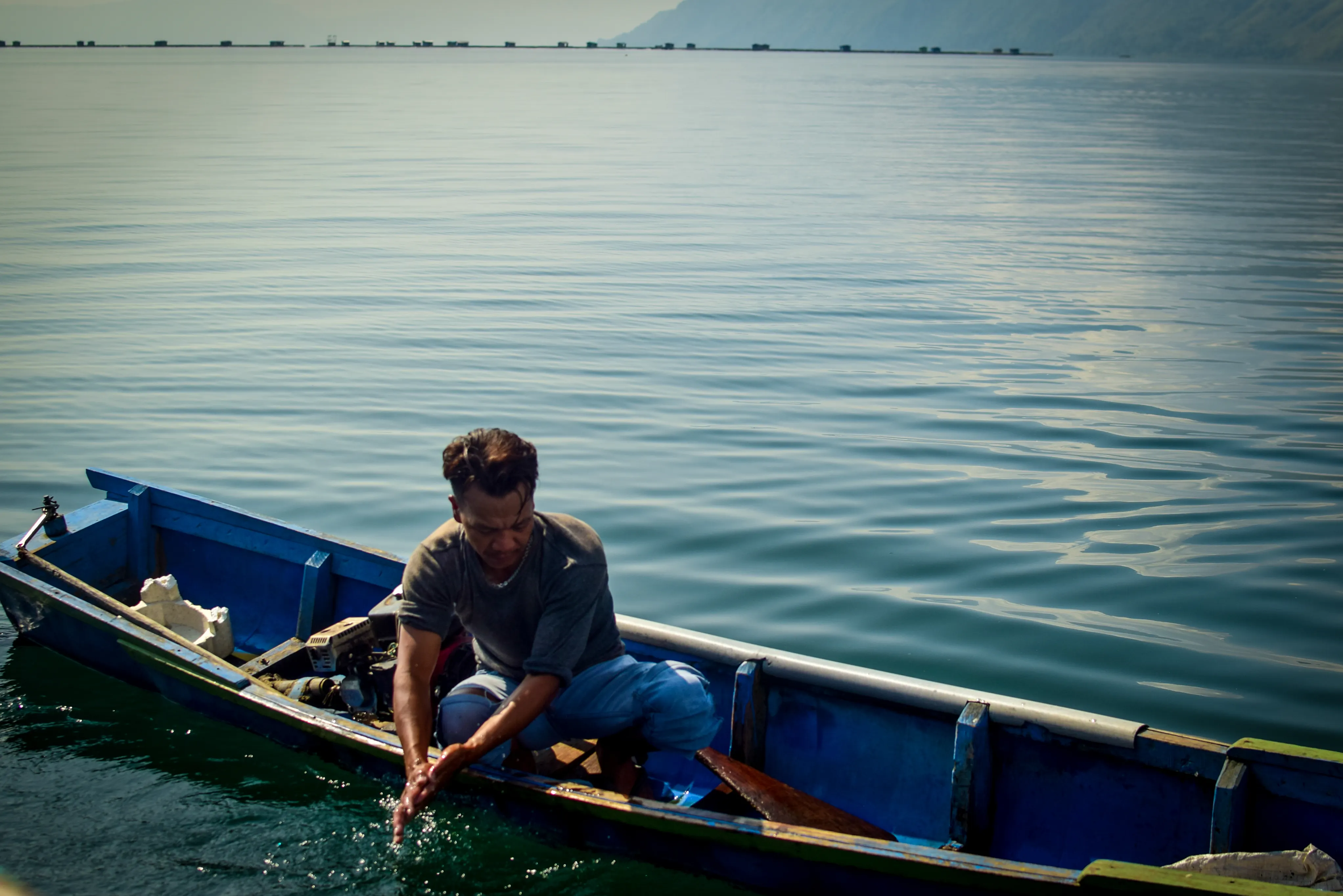 Fishmongers washing hands on Lake Toba